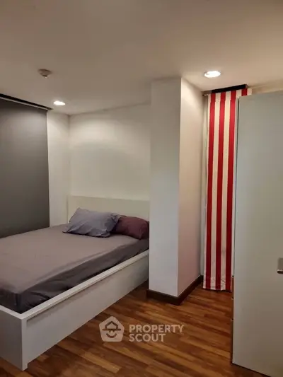 Cozy bedroom with modern decor and wooden flooring