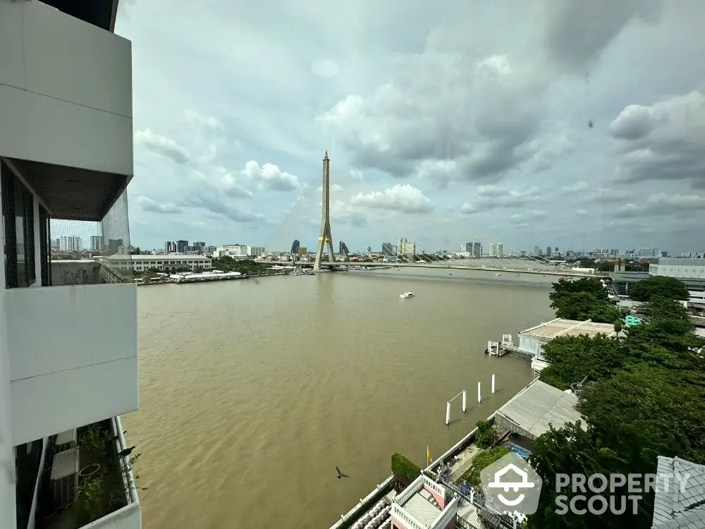 Stunning river view from high-rise apartment with iconic bridge in the background.