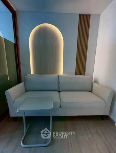 Modern living room with stylish sofa and unique wall lighting design