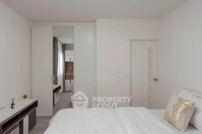 Modern minimalist bedroom with white decor and built-in wardrobe