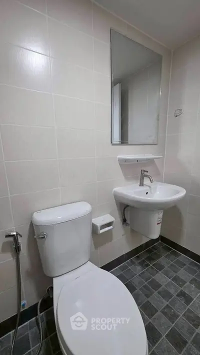 Modern bathroom with sleek fixtures and tiled flooring, perfect for a contemporary home.