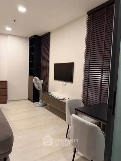 Modern living room with sleek furniture and stylish blinds, perfect for urban living.