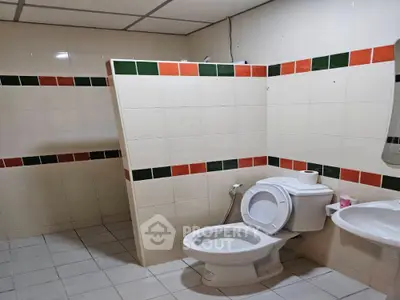 Spacious bathroom with tiled walls and modern fixtures