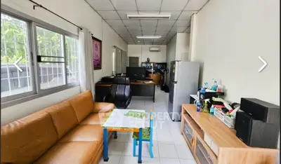 Spacious living room with modern furniture and natural light, perfect for family gatherings.