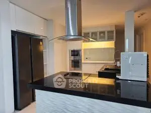 Modern kitchen with sleek black countertops and built-in appliances
