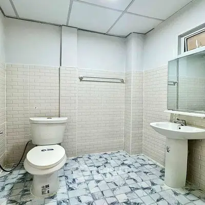 Spacious bathroom with modern white tiles and sleek fixtures