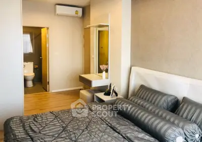 Modern bedroom with ensuite bathroom and stylish decor in a cozy apartment.