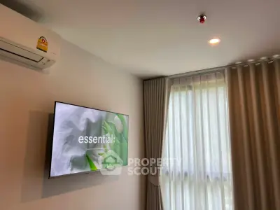 Modern living room with air conditioning and wall-mounted TV, featuring elegant curtains and soft lighting.