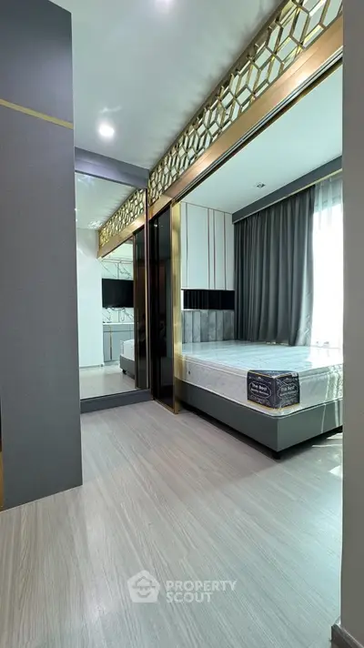 Luxurious bedroom with elegant decor and large mirror reflecting natural light