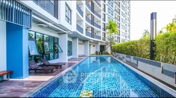 Luxurious condo with modern pool and lush greenery, perfect for relaxation and leisure.