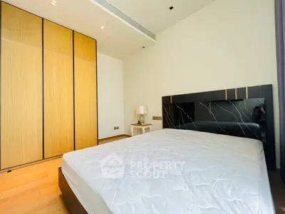 Modern bedroom with sleek design and wooden wardrobe