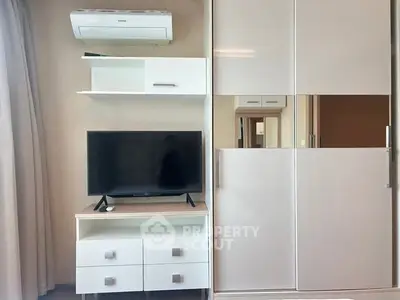 Modern living room with sleek TV stand and air conditioning unit, perfect for cozy entertainment.