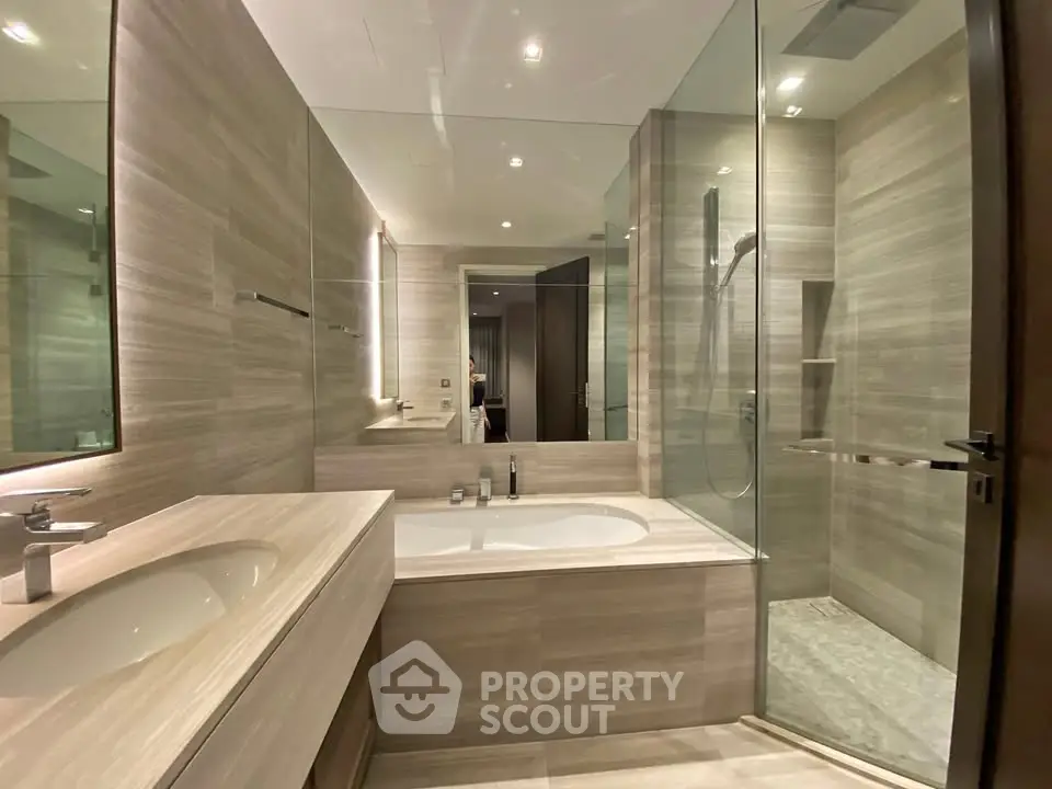 Luxurious modern bathroom with glass shower and elegant bathtub