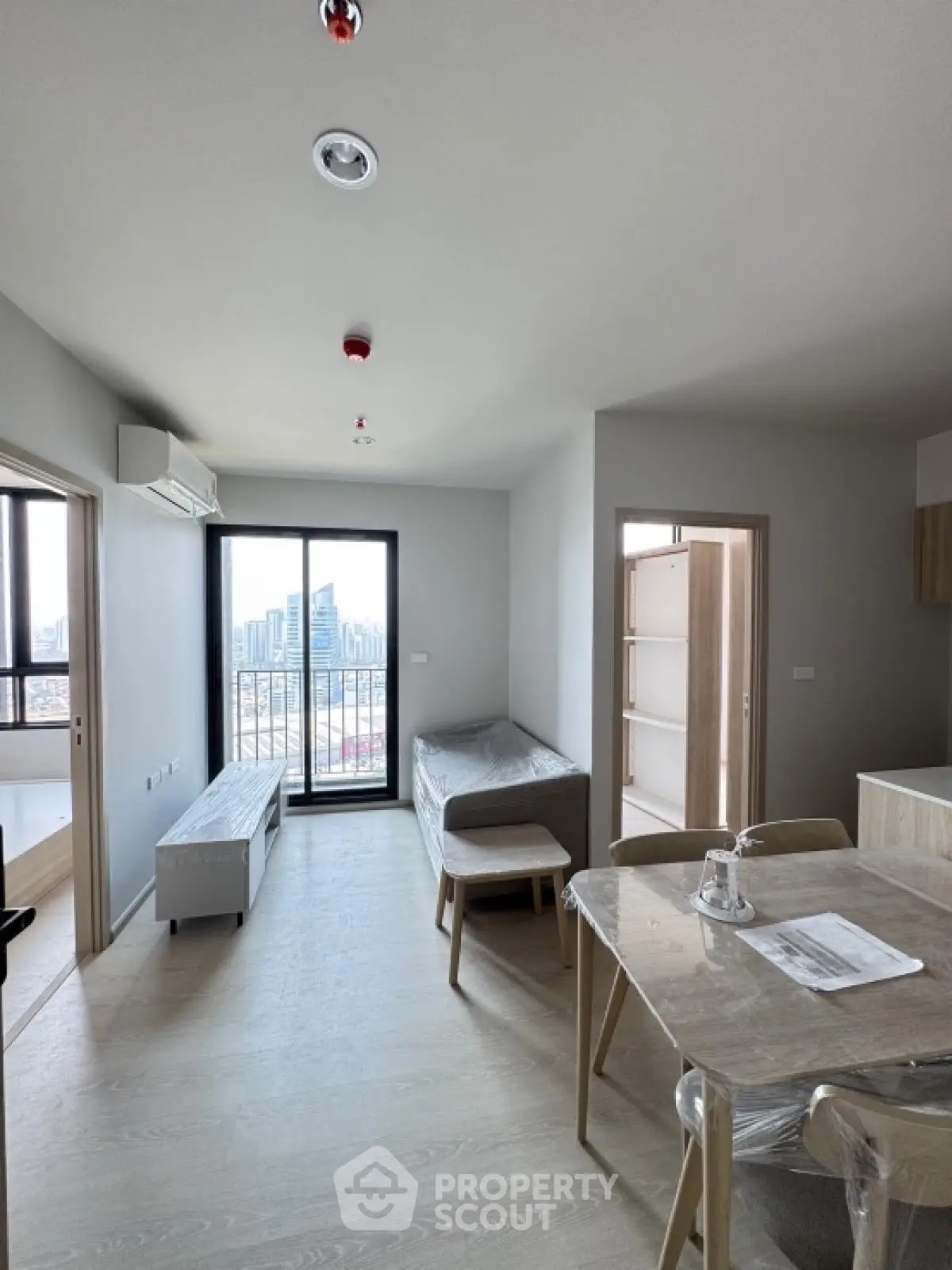 Modern apartment living room with city view and minimalist furniture