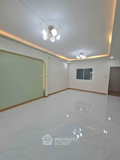 Spacious modern living room with elegant lighting and glossy tile flooring