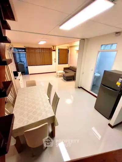 Spacious open-plan living and dining area with modern furnishings and natural light.