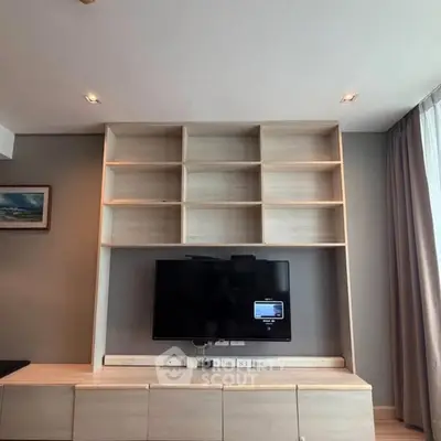 Modern living room with built-in TV unit and shelving