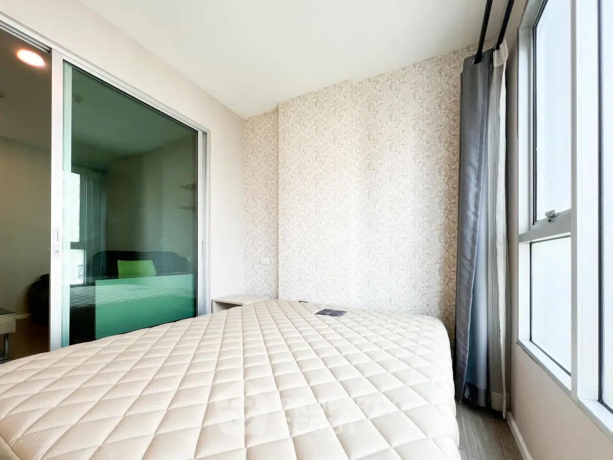 Bright and cozy bedroom with large windows and modern decor