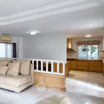 Spacious living room with open kitchen layout and modern furnishings