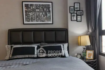 Stylish bedroom with modern decor and cozy ambiance, featuring elegant bedding and framed artwork.
