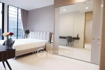 Modern bedroom with large mirrored closet and elegant decor