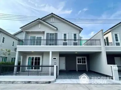 Modern two-story house with spacious balcony and garage in suburban neighborhood