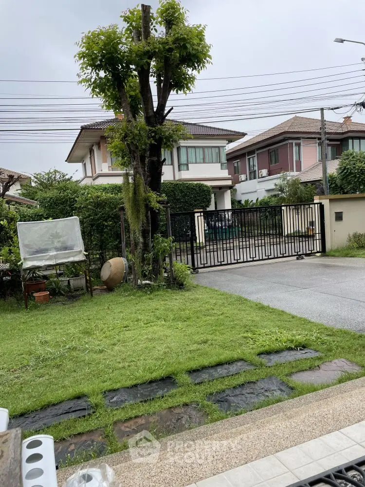 Charming suburban home with lush garden and secure gated entrance, perfect for family living.