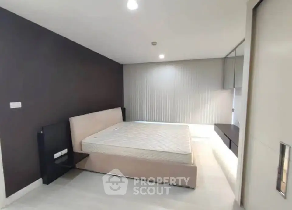 Spacious modern bedroom with sleek design and ample natural light