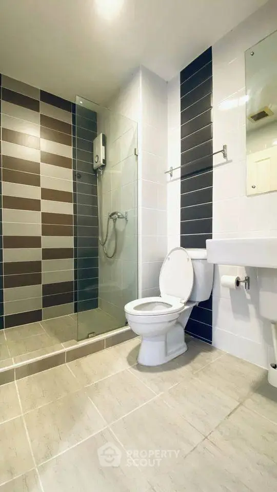 Modern bathroom with glass shower and sleek tile design