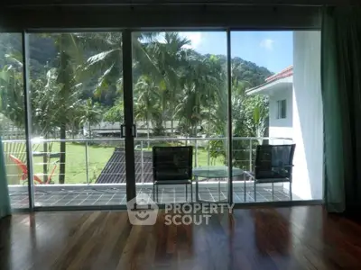 Spacious balcony with stunning tropical view and modern glass doors