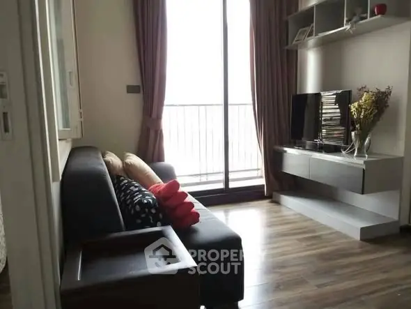 Cozy living room with modern decor and balcony access