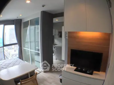 Modern studio apartment with city view, featuring sleek furniture and compact design.