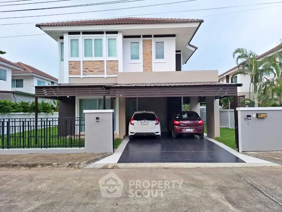 Modern two-story house with spacious driveway and lush garden in suburban neighborhood.