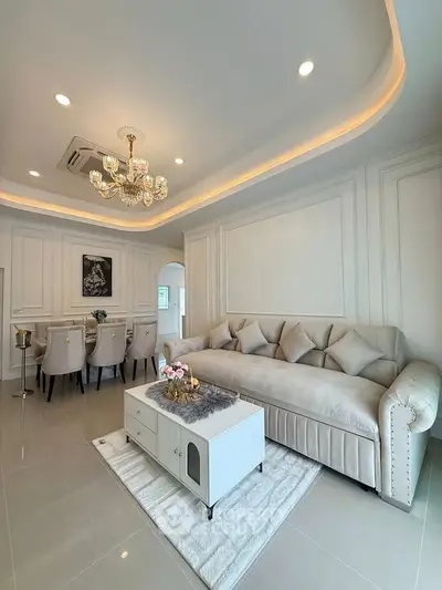 Luxurious living room with elegant chandelier and plush sofa in modern home