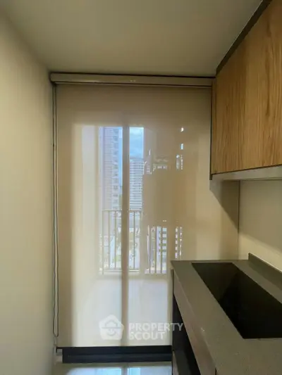 Modern kitchen with sleek design and city view through large window