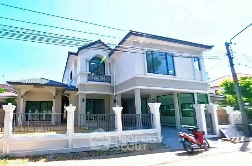 Elegant two-story house with modern design and spacious balcony in a serene neighborhood.