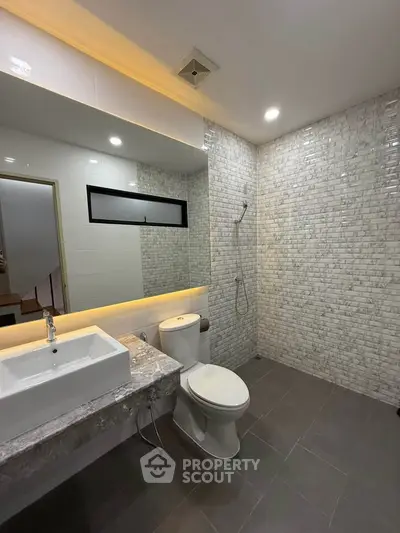 Modern bathroom with elegant tile design and sleek fixtures