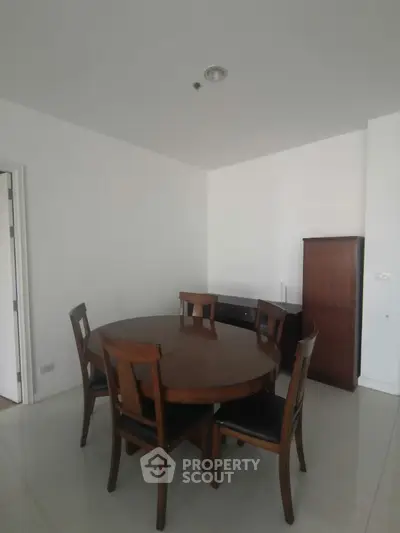 Spacious dining area with elegant wooden furniture in modern apartment