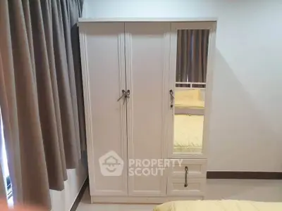 Elegant bedroom with stylish wardrobe and cozy curtains