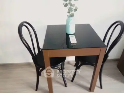 Chic dining nook with modern black table and chairs, perfect for cozy meals.