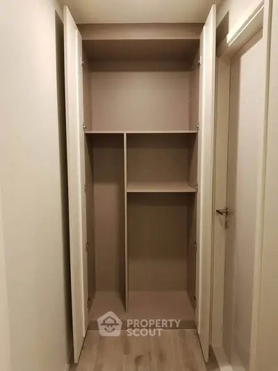 Spacious built-in closet with open shelving in modern apartment