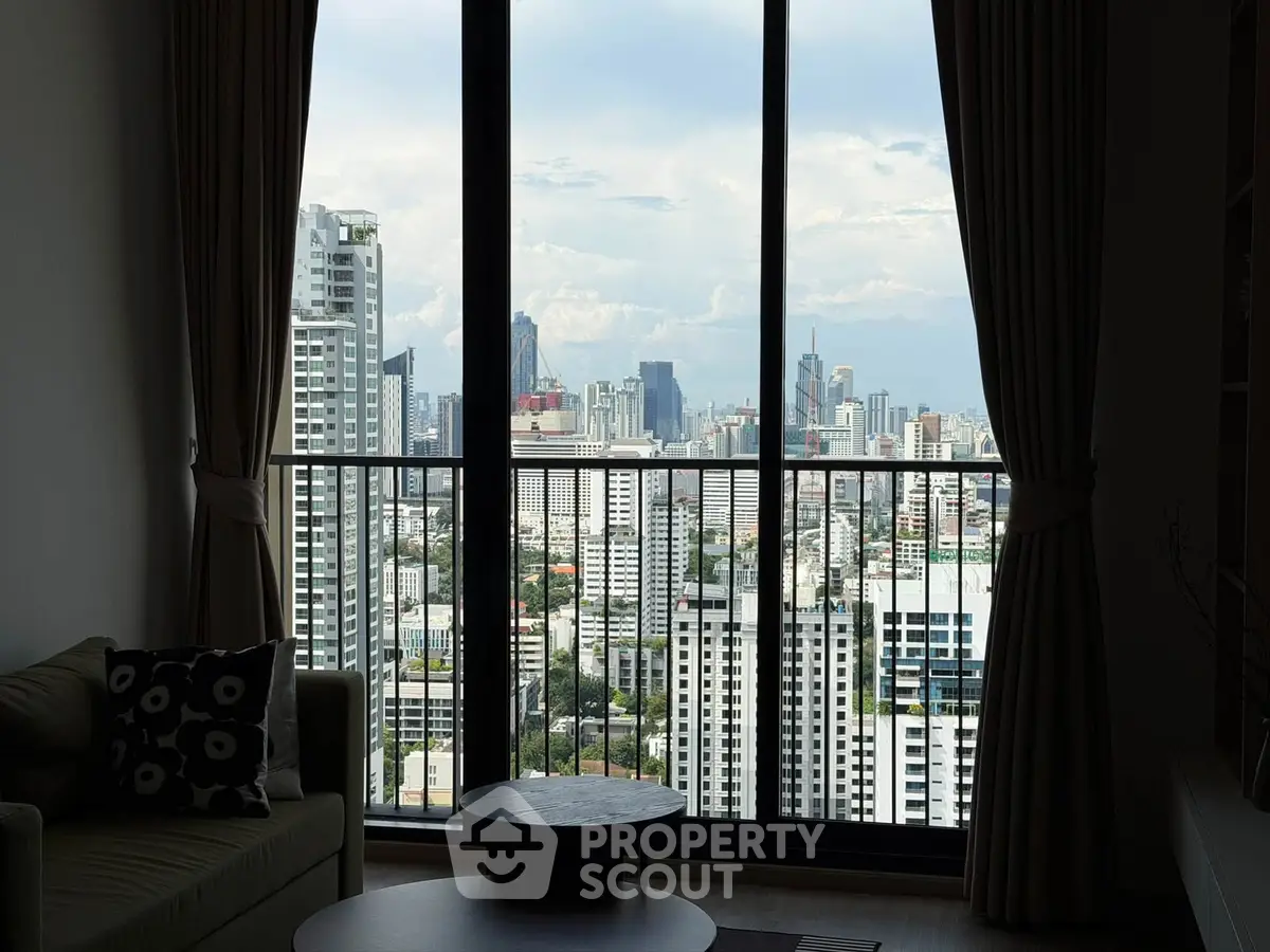 Stunning cityscape view from modern high-rise apartment living room with large windows.