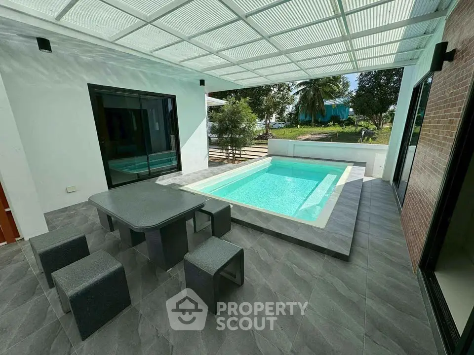 Modern patio with sleek pool and stylish outdoor furniture, perfect for relaxation and entertainment.