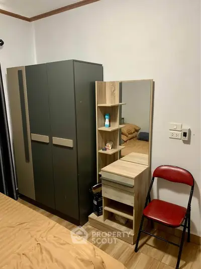 Cozy bedroom with modern wardrobe and stylish vanity set, perfect for urban living.