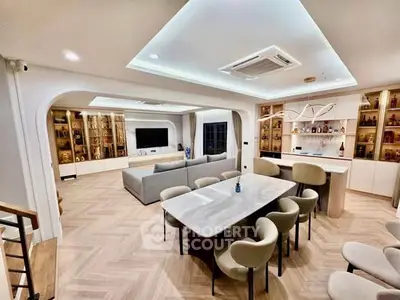 Luxurious open-plan living and dining area with modern decor and elegant lighting.