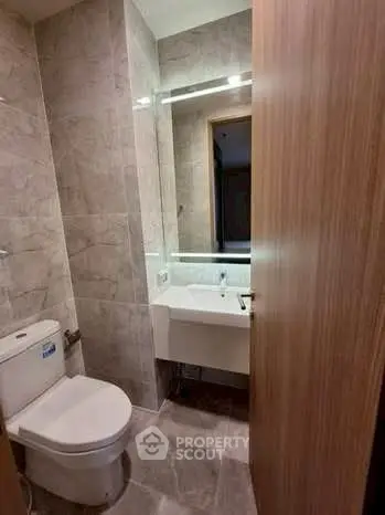 Modern bathroom with sleek fixtures and elegant tile design.