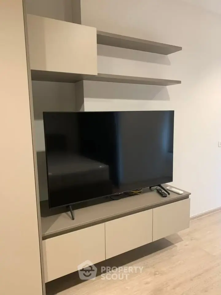 Modern living room with sleek TV unit and minimalist shelving