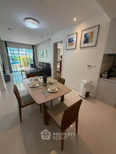 Modern living room with dining area and balcony view in a stylish apartment