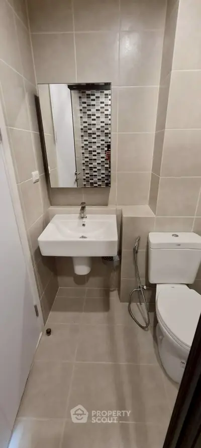Modern bathroom with sleek sink and toilet in neutral tones