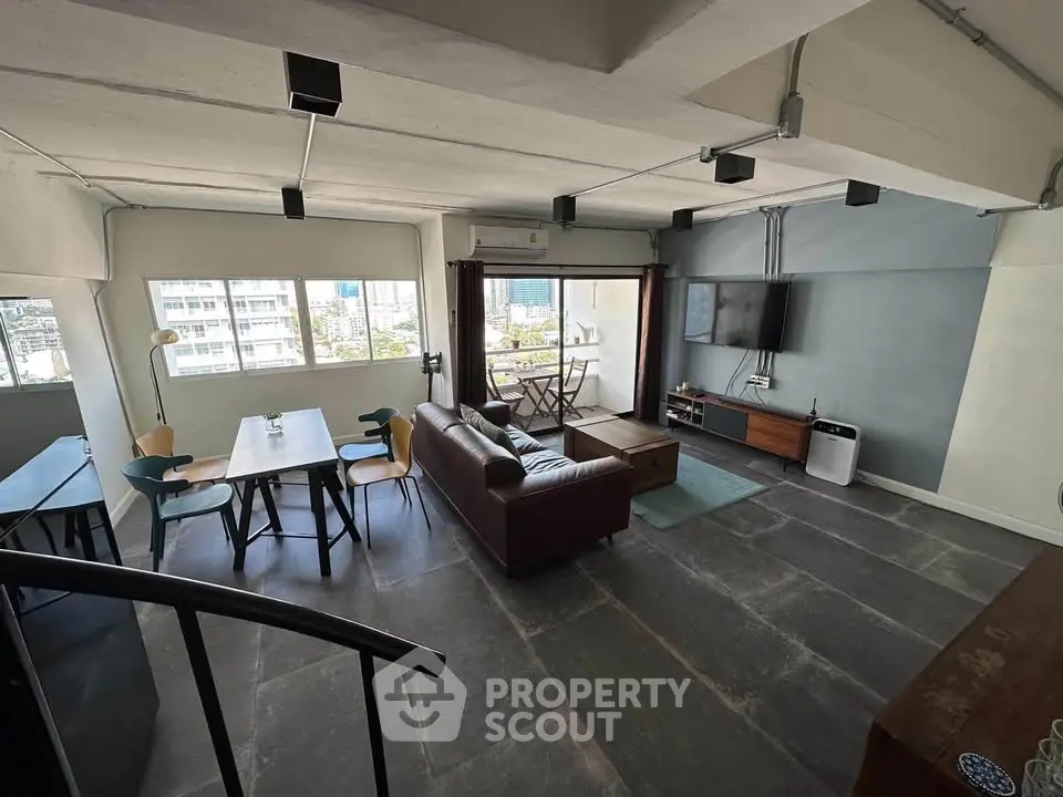 Spacious modern living room with city view, stylish furniture, and open layout.